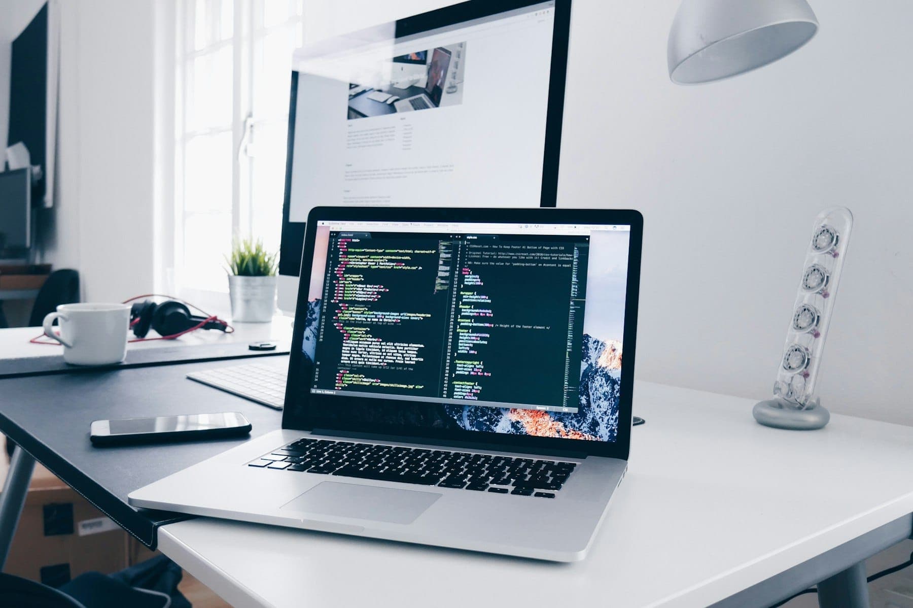 A developer working on mobile app code at a desk