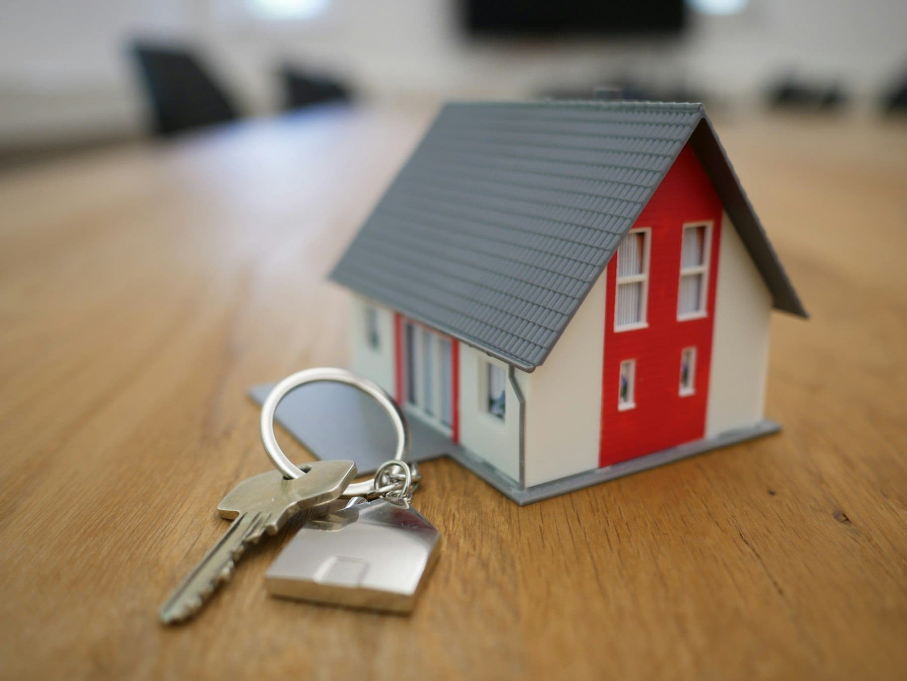 A property dealer reviewing listings on a phone at a desk