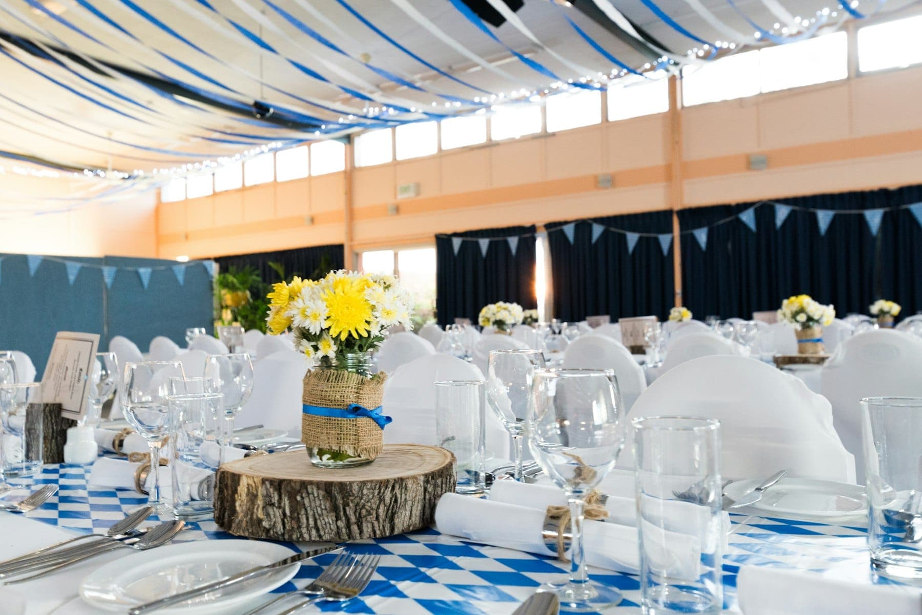 A decorated banquet hall set up for a wedding reception